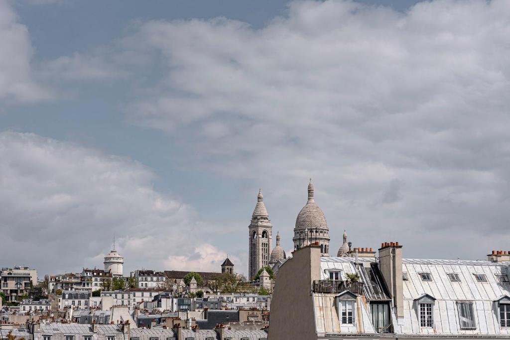 a view of a city with buildings in the background at Grand Pigalle Hotel in Paris