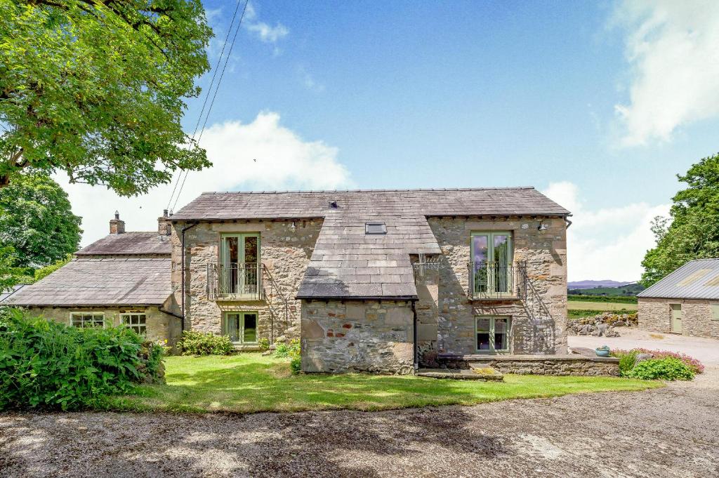 an old stone house with a roof at Pickle Barn in Lupton