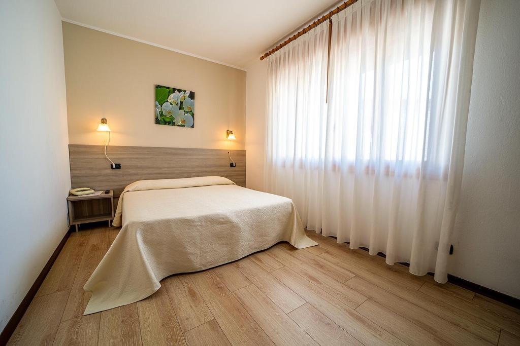 Postel nebo postele na pokoji v ubytování Hotel da Romagnolo