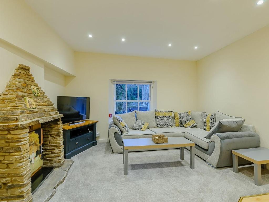 a living room with a couch and a fireplace at Vine Cottage in Broadstairs