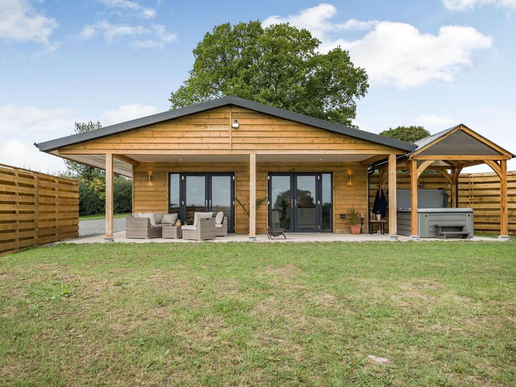 a log home with a pitched roof at Bramley Lodge - Uk38384 in Lyonshall