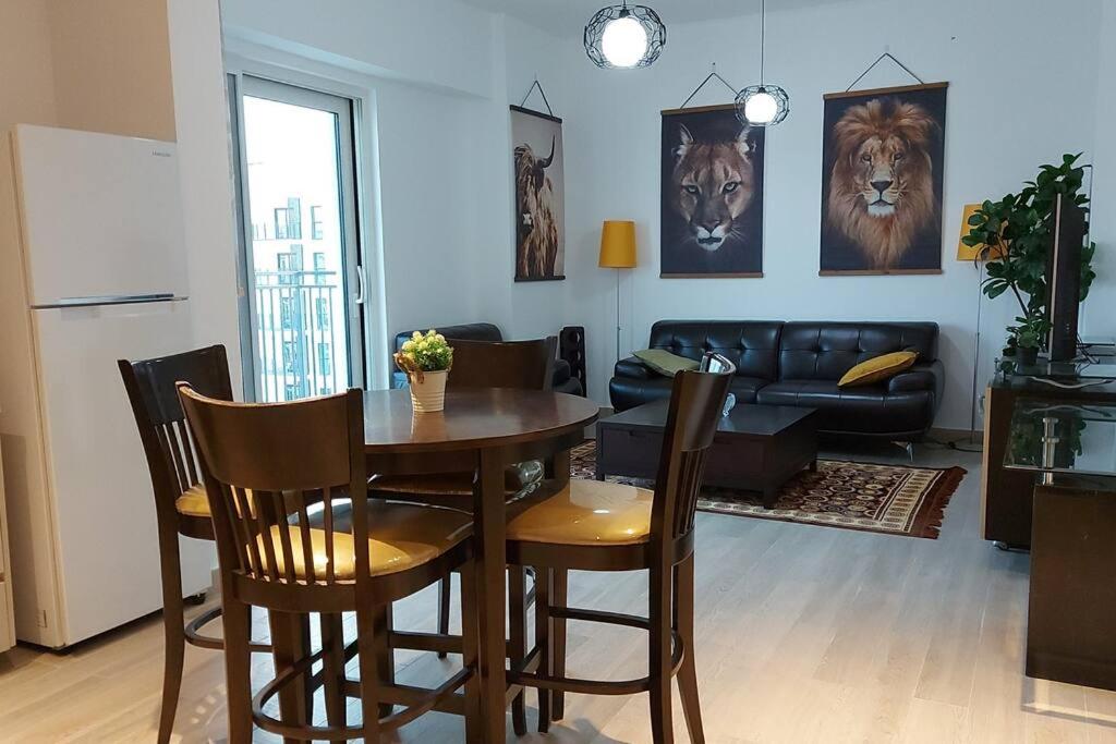 een woonkamer met een tafel en stoelen en een bank bij Deluxe Apartment on YAS with Sea View Balcony in Abu Dhabi
