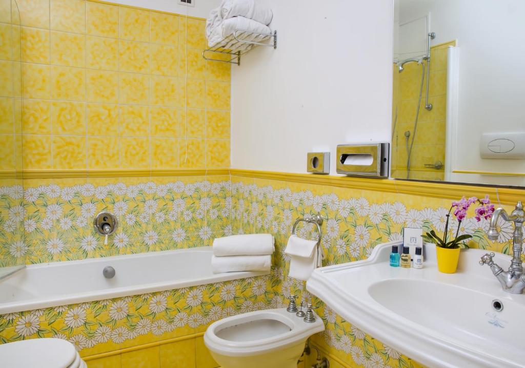 a bathroom with a tub and a toilet and a sink at Relais Maresca Luxury Small Hotel & Terrace Restaurant in Capri