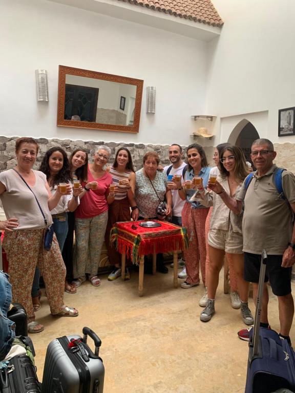 a group of people posing for a picture with wine glasses at Hostel BE 20 in Marrakech