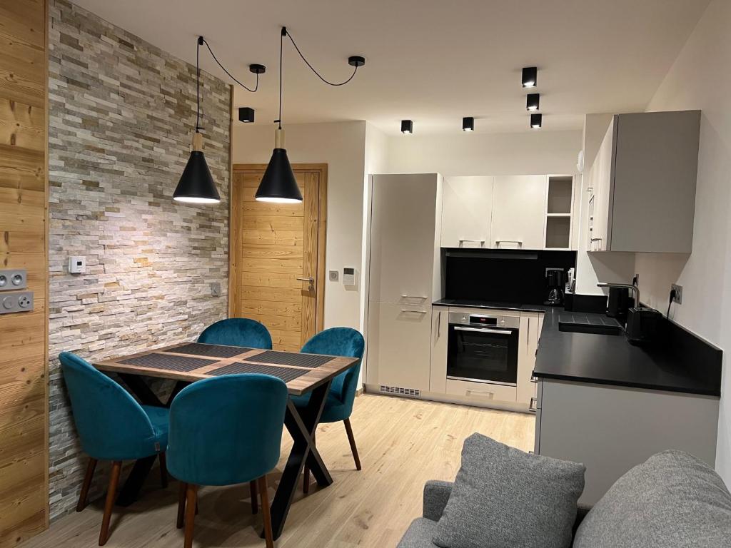 a kitchen and dining room with a table and chairs at CARLINA 105 in Morzine