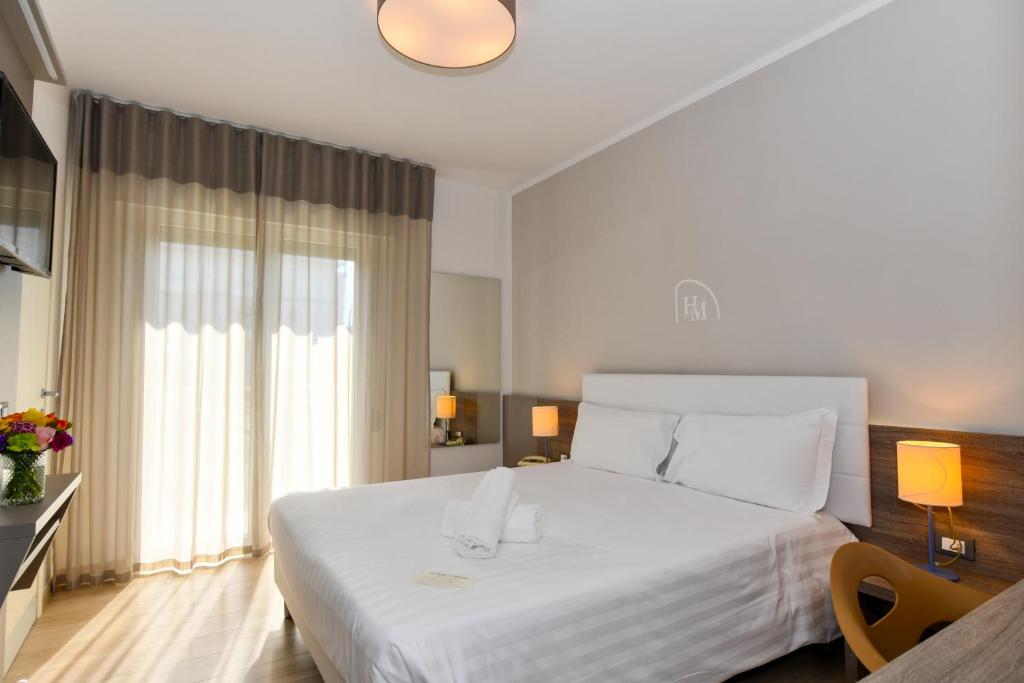 Postel nebo postele na pokoji v ubytování Hotel Delle Mimose