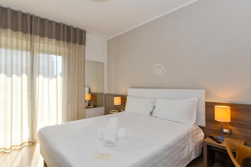 Postel nebo postele na pokoji v ubytování Hotel Delle Mimose