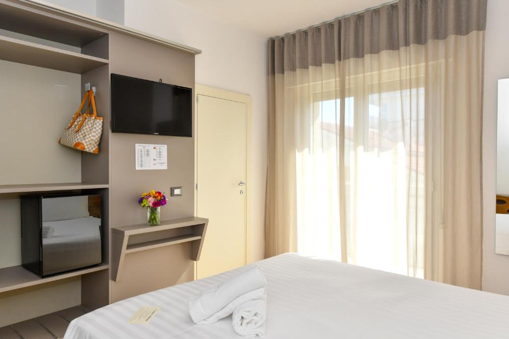 Postel nebo postele na pokoji v ubytování Hotel Delle Mimose