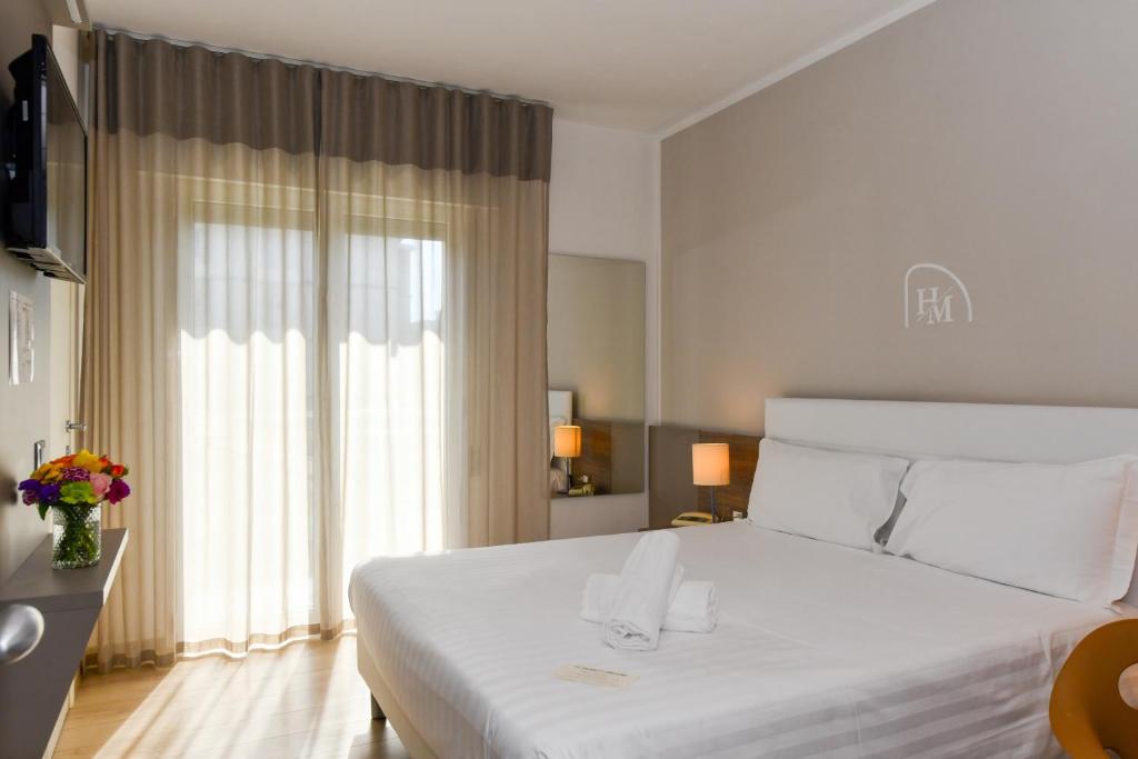 Postel nebo postele na pokoji v ubytování Hotel Delle Mimose