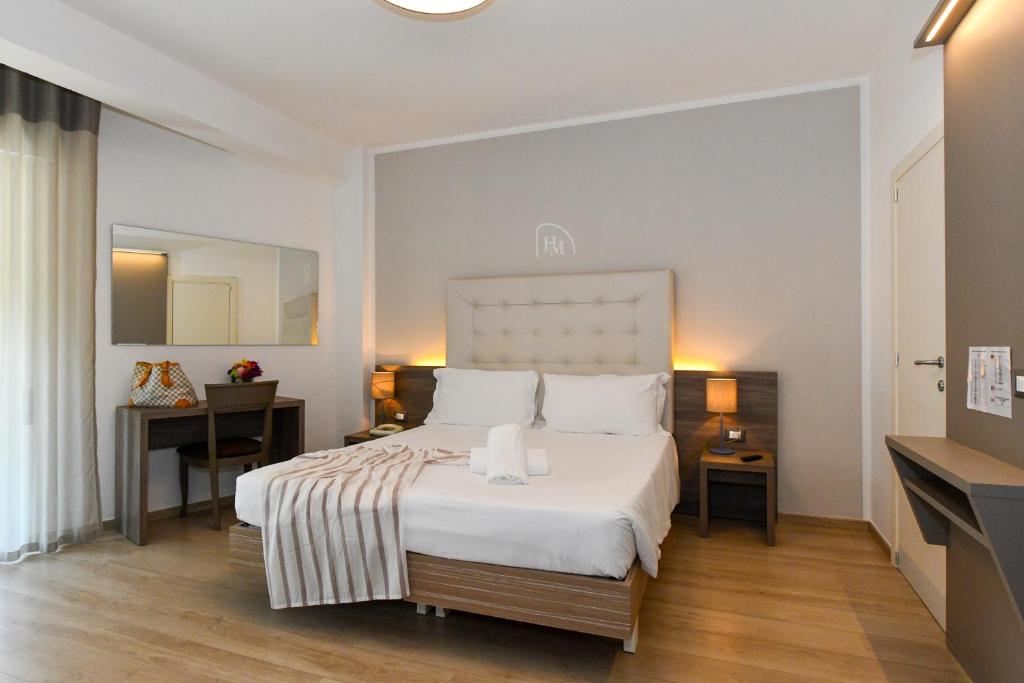 Postel nebo postele na pokoji v ubytování Hotel Delle Mimose