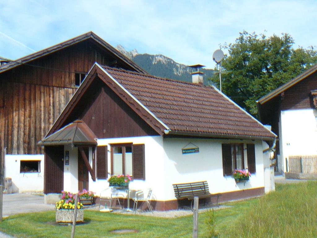 a house with a brown and white at Ferienhäuschen Kathrein in Ehenbichl