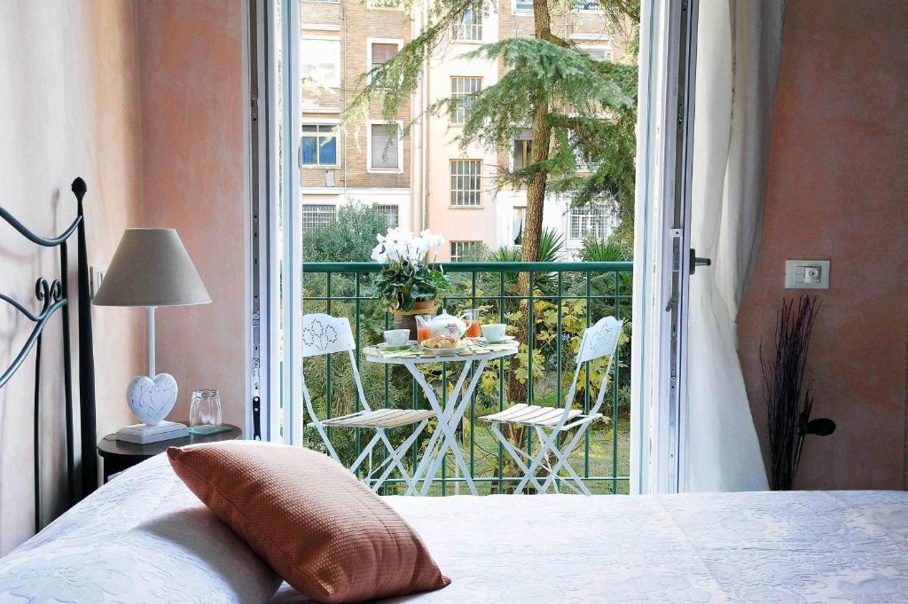 a bedroom with a bed and a balcony with a table at Sweet Dreams in St Peter B&b in Rome