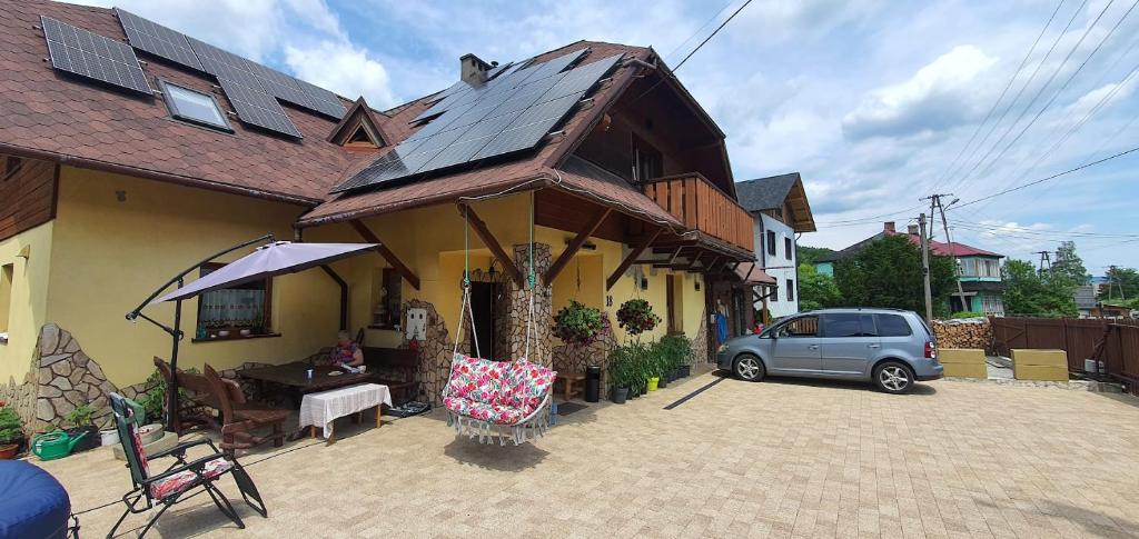 a house with a car parked in front of it at Pokoje Gościnne Kacper Blisko Gondoli in Szczyrk