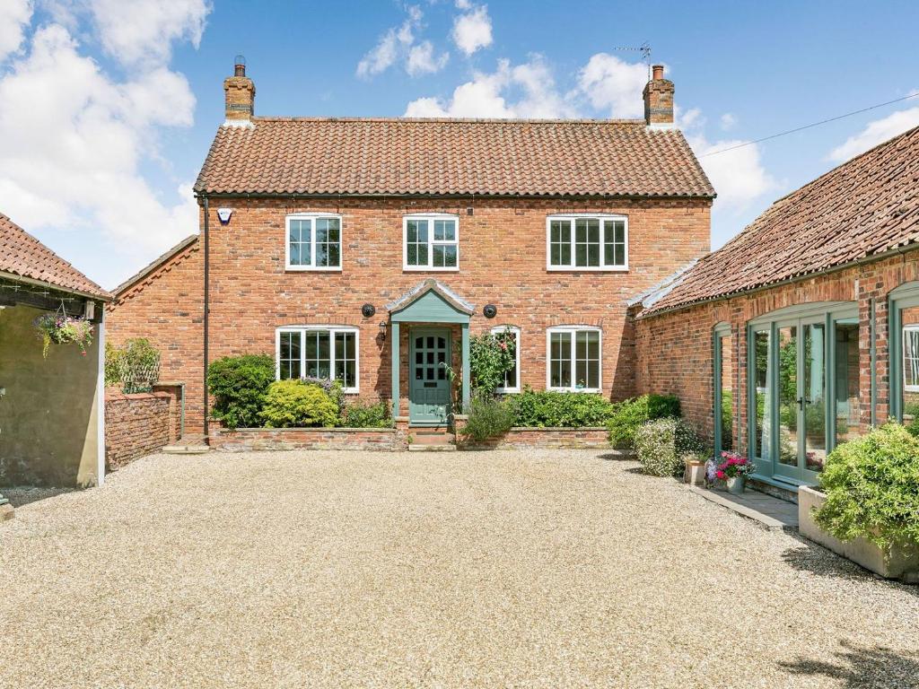 an exterior view of a brick house with a driveway at The Hemmels in Brinkhill