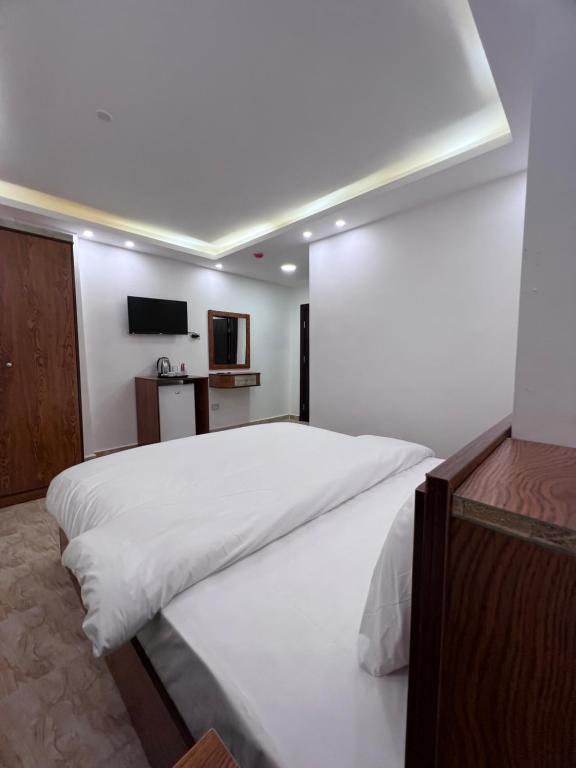 Postel nebo postele na pokoji v ubytování Petra Family Hotel