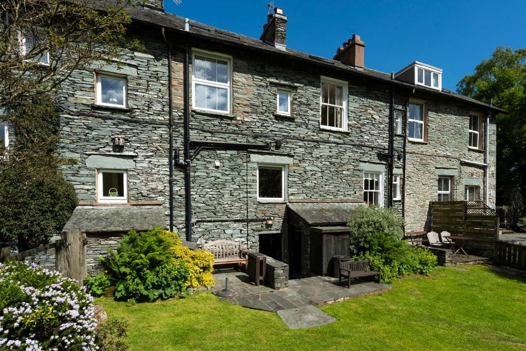 an old stone house with a garden in front of it at Oak Cottage Chapel Stile in Chapel Stile
