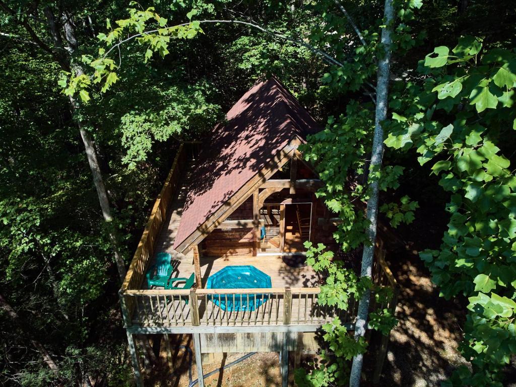 a small house in the middle of a forest at Gatlinburg Adventure Cabins in Sevierville