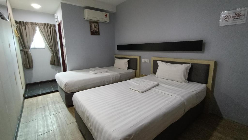 Postel nebo postele na pokoji v ubytování Unikarya Lodge