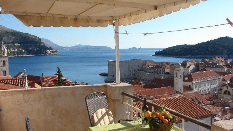 a view of a city and the ocean from a balcony at Apartments Lucic in Dubrovnik