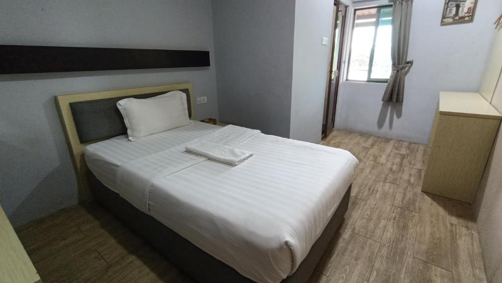 Postel nebo postele na pokoji v ubytování Unikarya Lodge