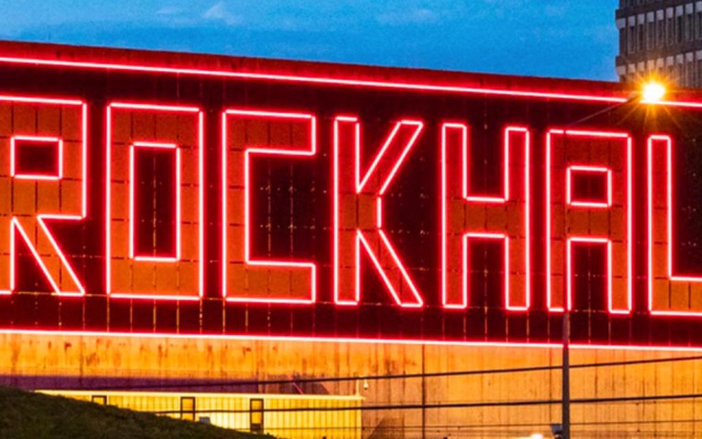 a large neon sign on the side of a building at Hotel Monvillage in Mondercange