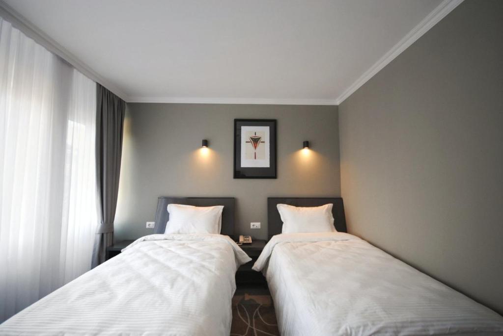 Postel nebo postele na pokoji v ubytování Hotel Callisto
