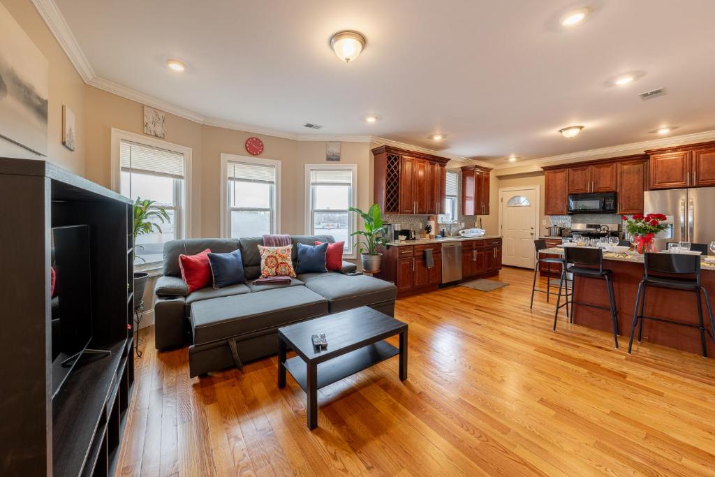 a living room with a couch and a kitchen at 90-Boston Spacious Convenient Apartment in Boston