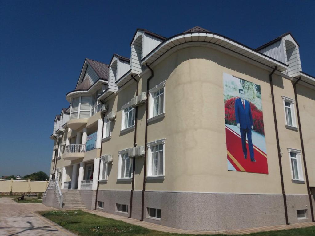 a building with a painting of a man on the side at Bahri Tojik Resort & Spa in Kairakum