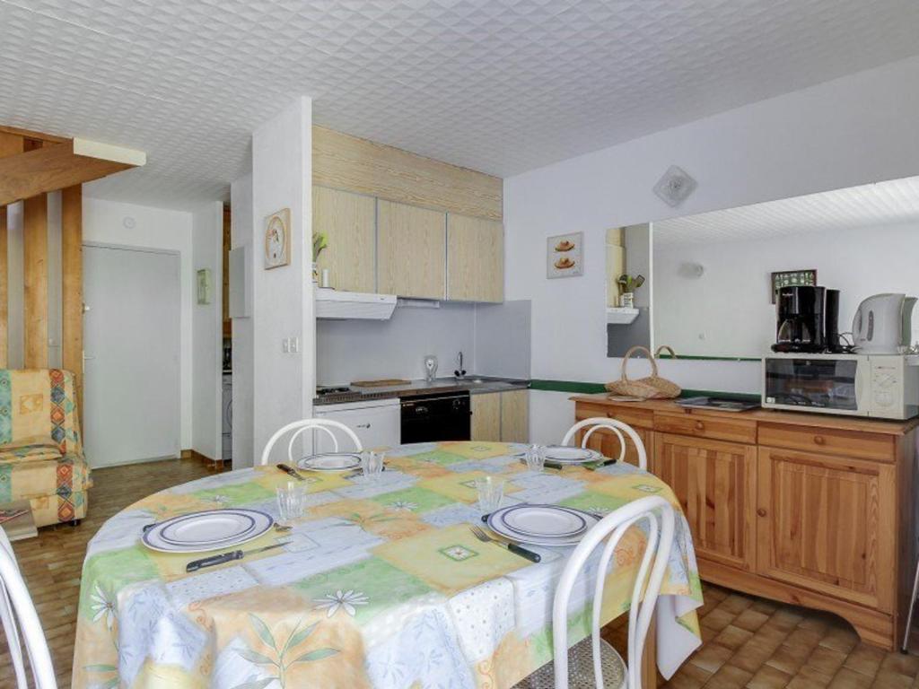 a kitchen with a table with plates on it at Appartement Luz-Saint-Sauveur, 3 pièces, 6 personnes - FR-1-402-44 in Luz-Saint-Sauveur