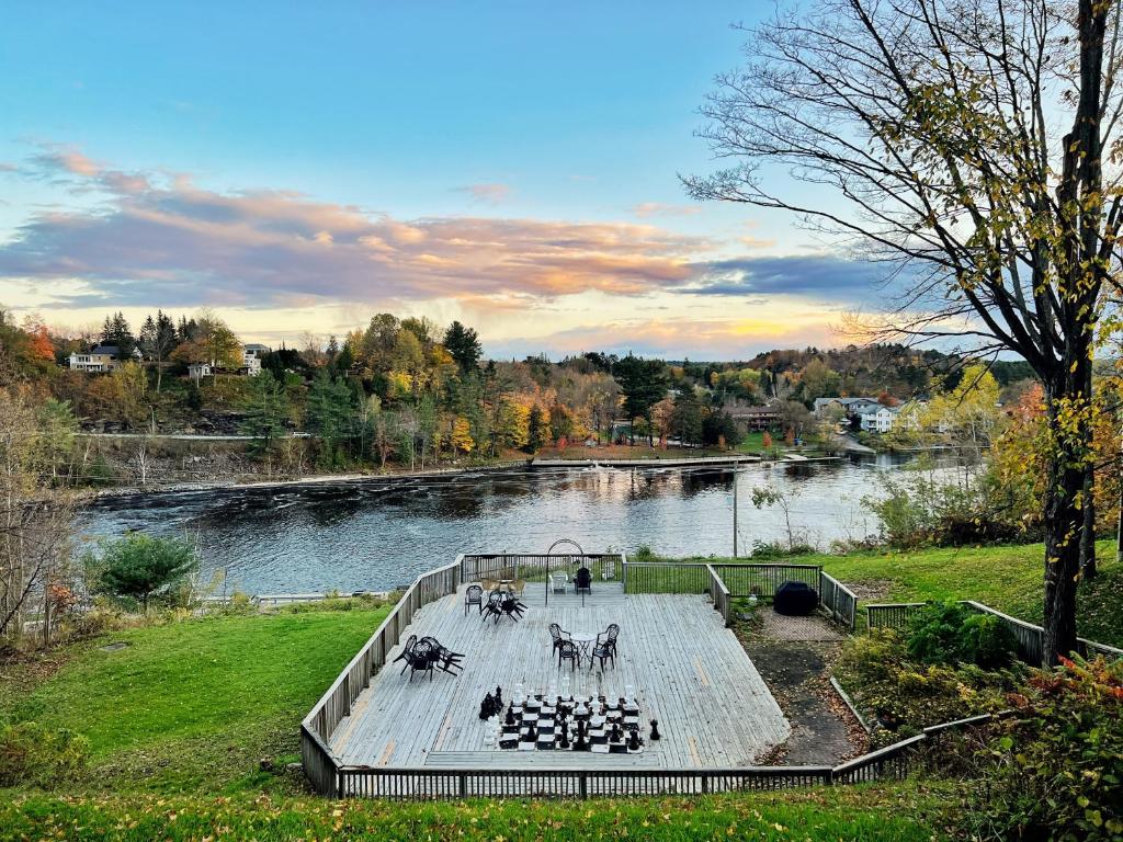 two statues of animals on a dock next to a river at Inn at the Falls in Bracebridge