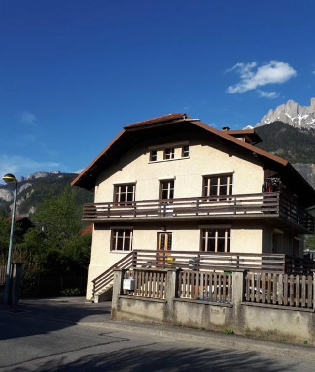une grande maison blanche avec une clôture devant elle dans l'établissement Chambres à Sallanches, à Sallanches