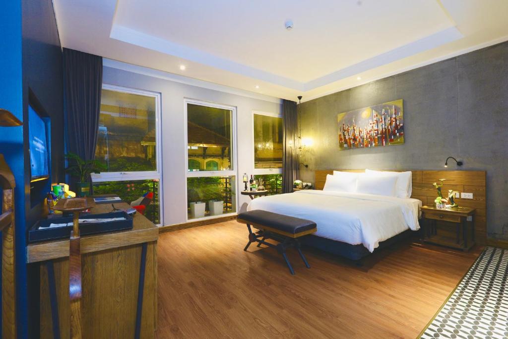Postel nebo postele na pokoji v ubytování HaNoi Calido Hotel