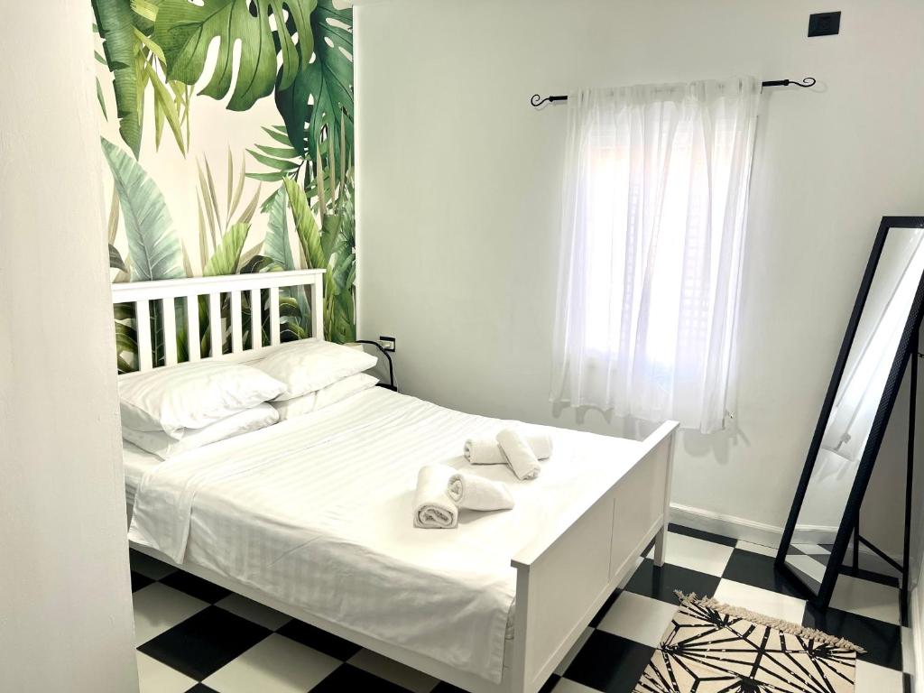 a bedroom with a white bed with towels on it at Shantell Luxury Apartment in Netanya