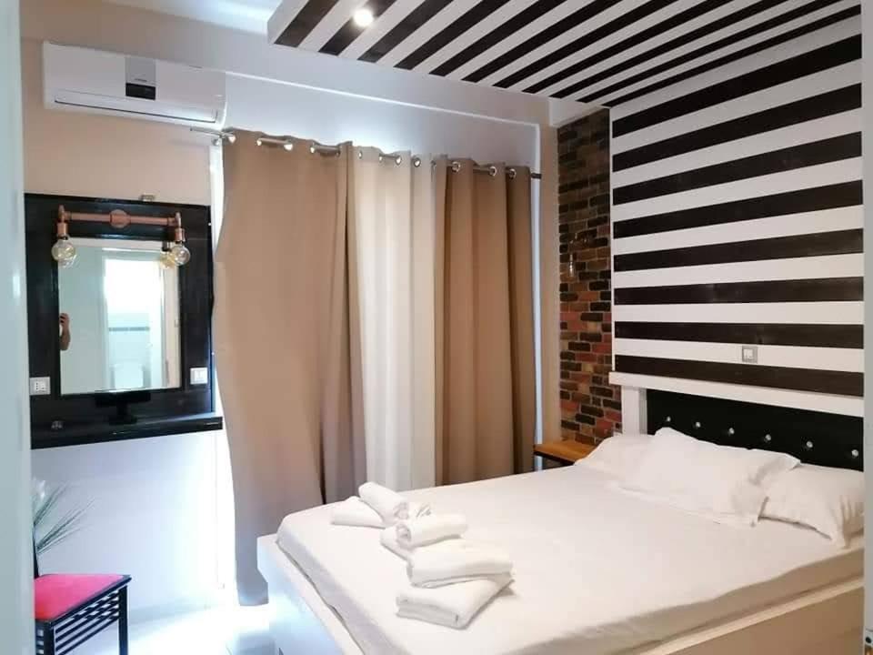 a bedroom with a bed with white towels on it at Jz boutique apartments in Rhodes Town