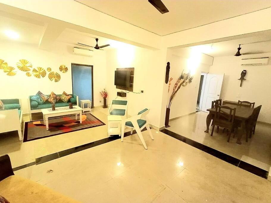 a living room with a couch and a piano at Siolim 6bhk Private Villa with Private Pool close to Anjuna Vagator in Siolim