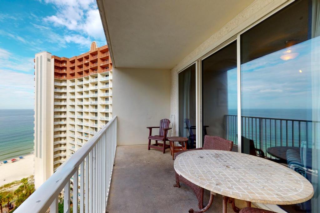 a balcony with a table and a view of the ocean at Shores of Panama 1615 in Panama City Beach