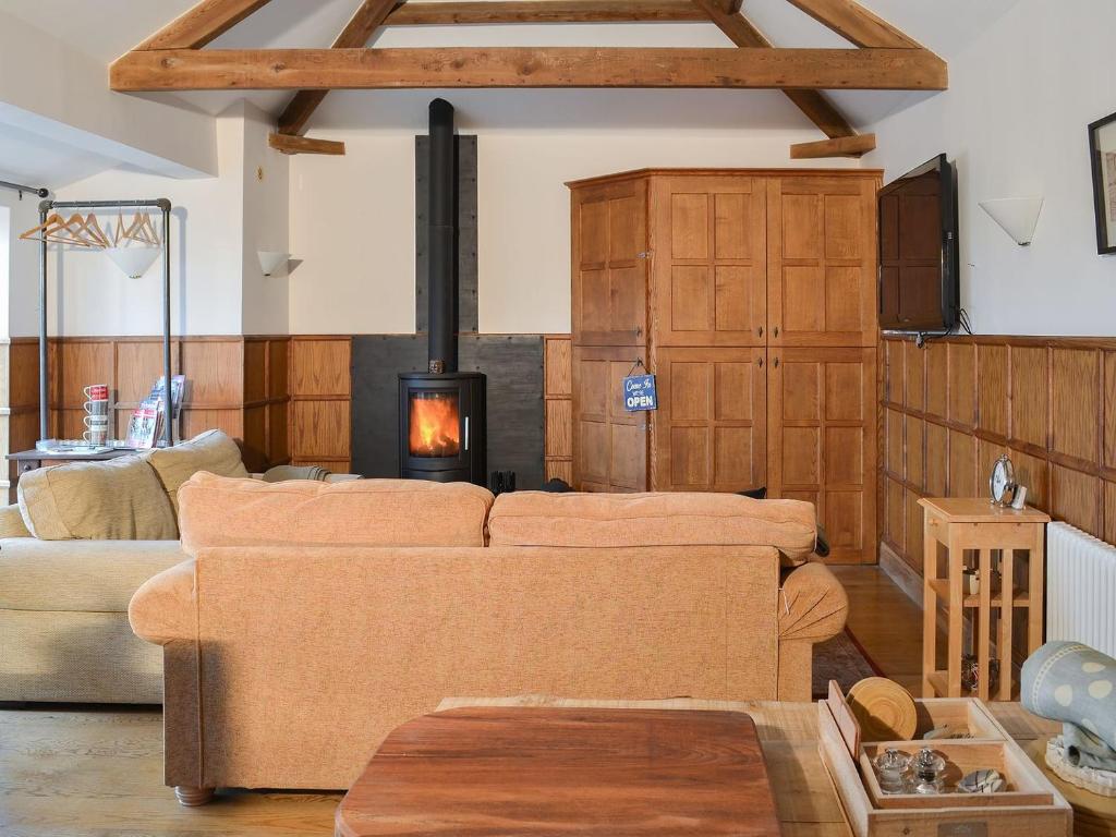 a living room with a couch and a fireplace at Graces Retreat in Eryholme