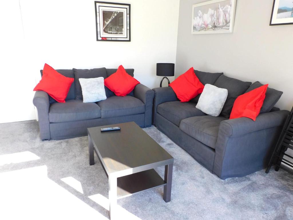 a living room with two couches and a coffee table at Charming 2 bed house Perfect base for sightseeing in Johnstone