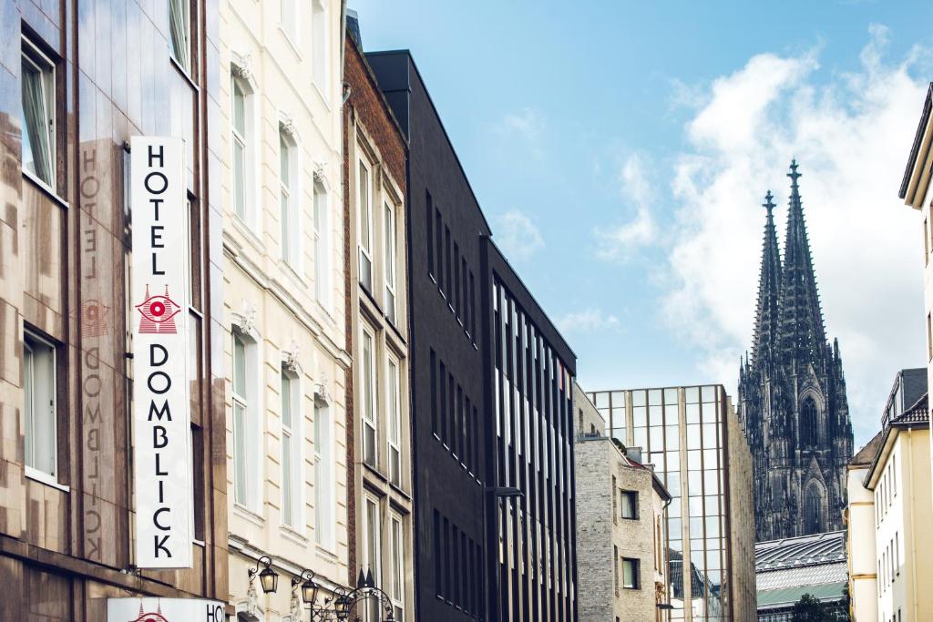 a city street with buildings and a church at Hotel Domblick Garni in Cologne