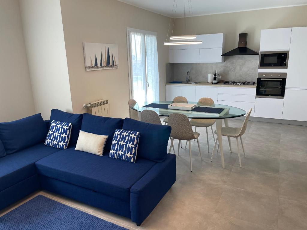 a living room with a blue couch and a table at Appartamento Luigi in Ventimiglia