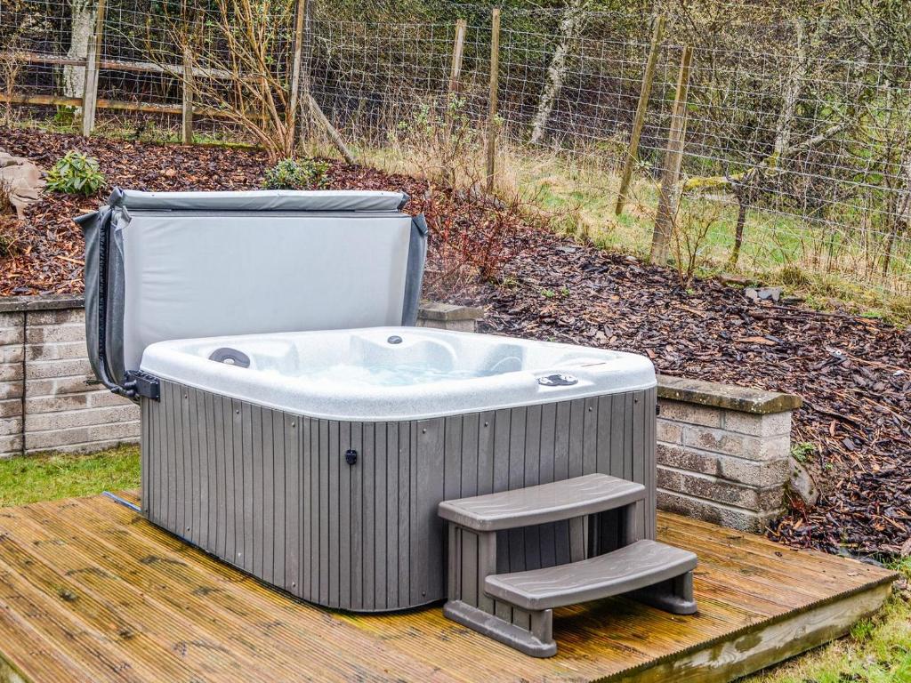 a bath tub sitting on a wooden deck at Woodside in Blairgowrie