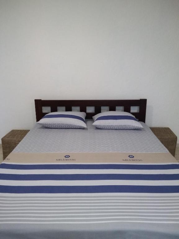 a bed with blue and white striped sheets and pillows at Центр 95 квартала, Смарт-TV in Kryvyi Rih