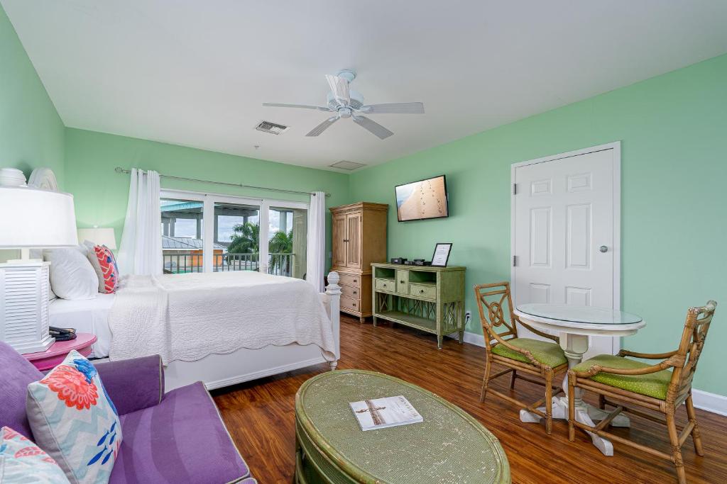 a bedroom with a bed and a table in a room at Harbour House at the Inn 310 in Fort Myers Beach