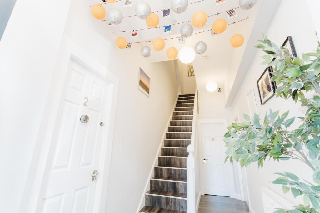 a staircase in a house with oranges on the ceiling at Sweet Suites Lytham in Lytham St Annes