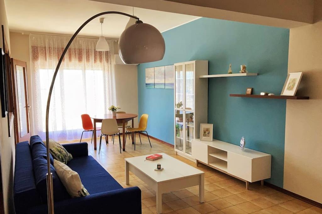 a living room with a blue couch and a table at Casa vacanze IL NIDO - 4 stelle in Milazzo