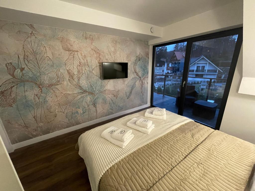 Posteľ alebo postele v izbe v ubytovaní Apartament Szklarski Widok