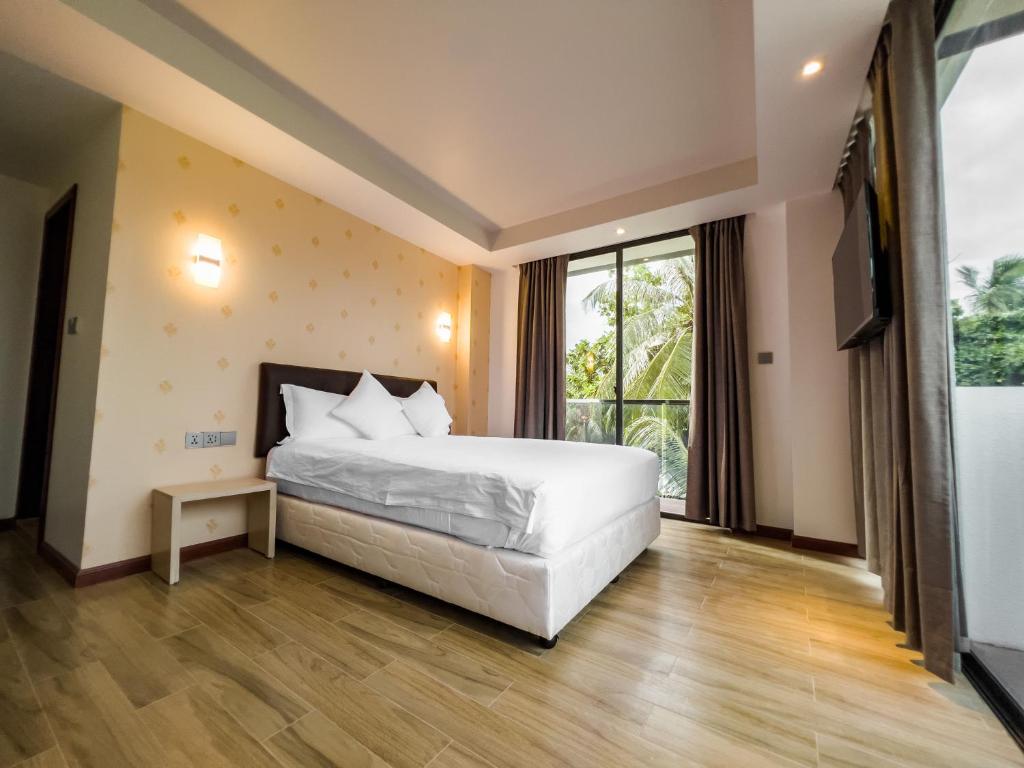 Postel nebo postele na pokoji v ubytování Ari Grand Hotel & Spa