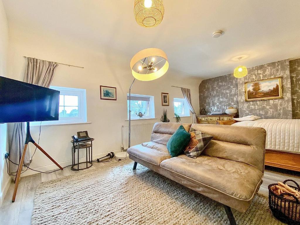 a living room with a couch and a bed at Station Suite 1 - Uk40737 in North Tidworth