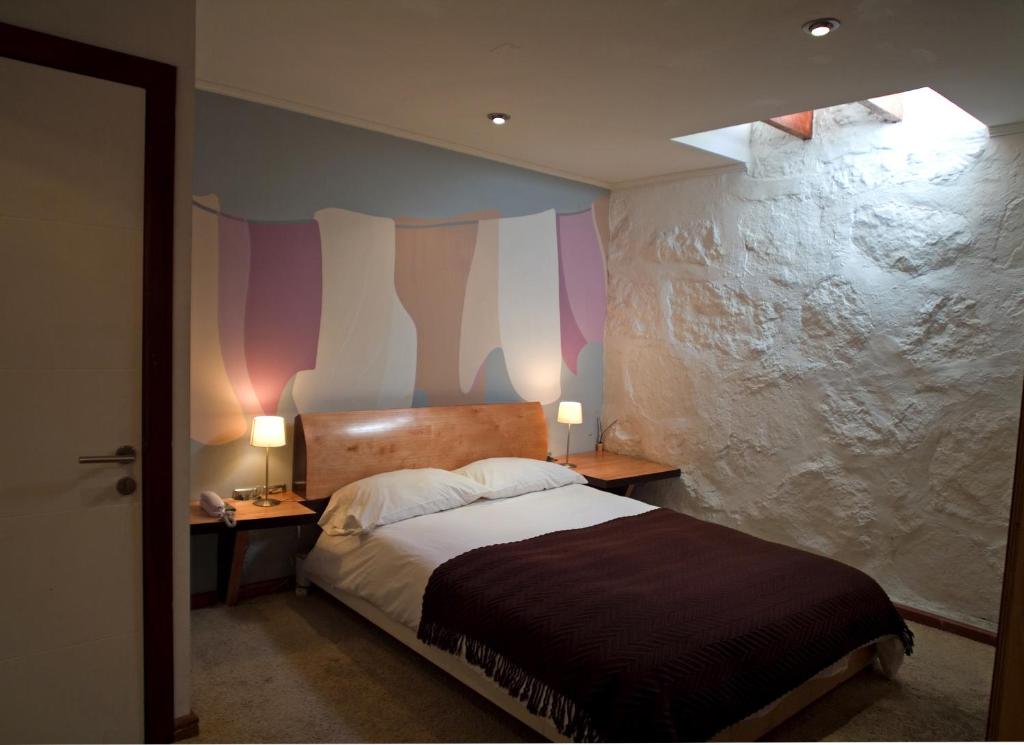 A bed or beds in a room at Hotel Latitud 33º Sur