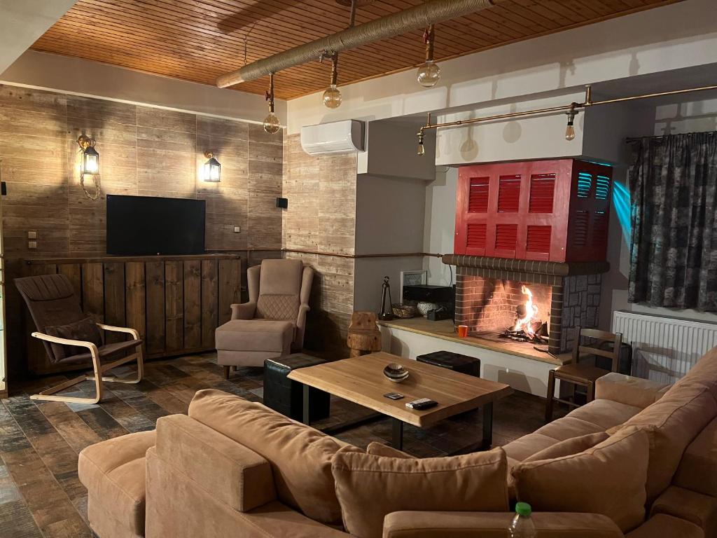 a living room with a couch and a fireplace at Ονειρεμένο διαμέρισμα Ν1 in Theologos